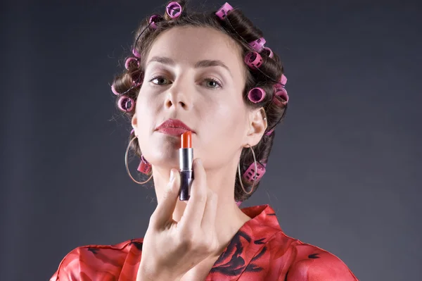 stock image Beautiful young woman with bigoudi on the hair