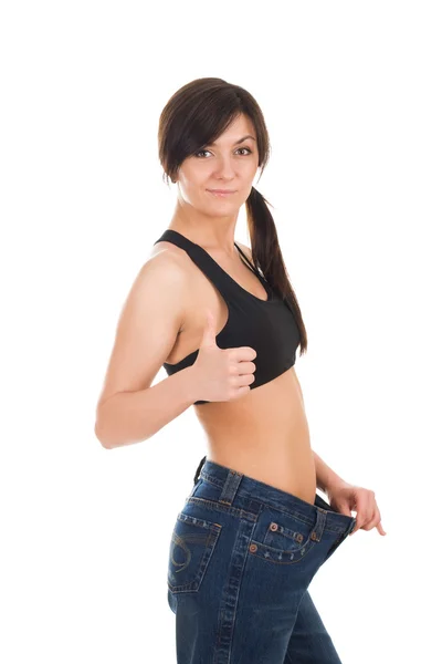 Giovane donna con i suoi vecchi jeans dopo aver perso peso — Foto Stock