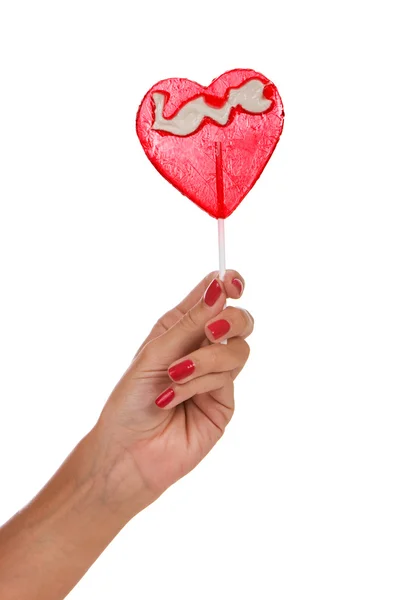 Heart shape lollipop in a hand — Stock Photo, Image