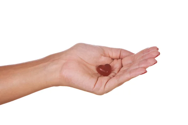 Szív alakú cukorkát a kéz — Stock Fotó