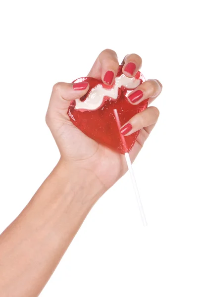 Hjärta form lollipop i en hand — Stockfoto