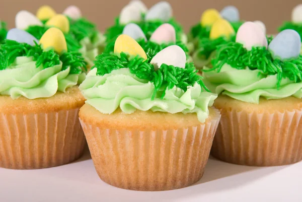 Many Easter Cupcakes with Candy Eggs — Stock Photo, Image