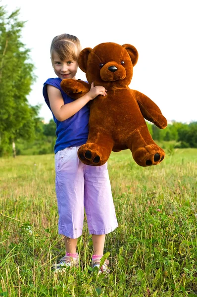 stock image Girl with teddy bear in a meadow