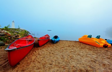 Canoes and kayaks at sunrise clipart