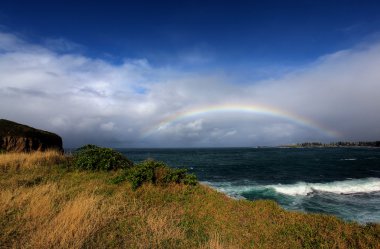 Rainbow over the ocean clipart