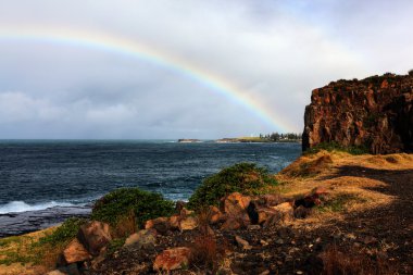 Rainbow over the ocean clipart