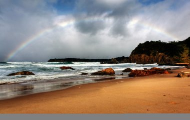 Rainbow over the ocean clipart