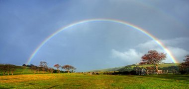 Rainbow over a farm clipart