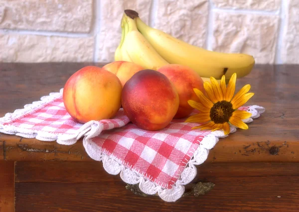 stock image Peaches and bananas on the table