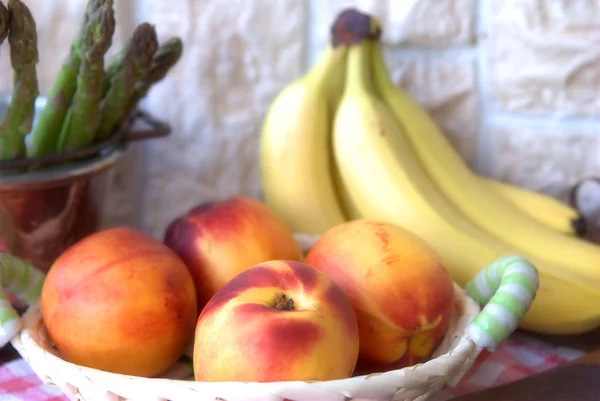 Stock image Peaches and bananas on the table