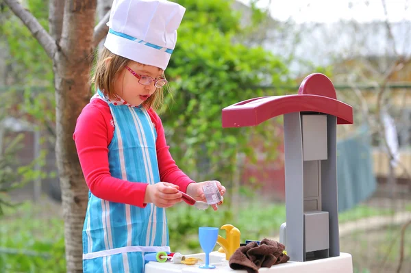 Little girl having fun playing cooking — Stock Photo, Image