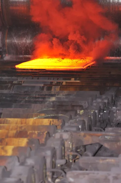 Hot steel on conveyor — Stock Photo, Image