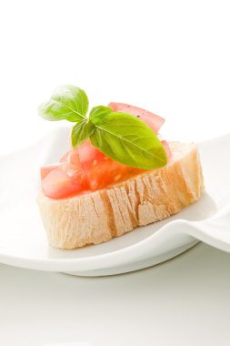 Bruschetta with tomatoes and basil isolated