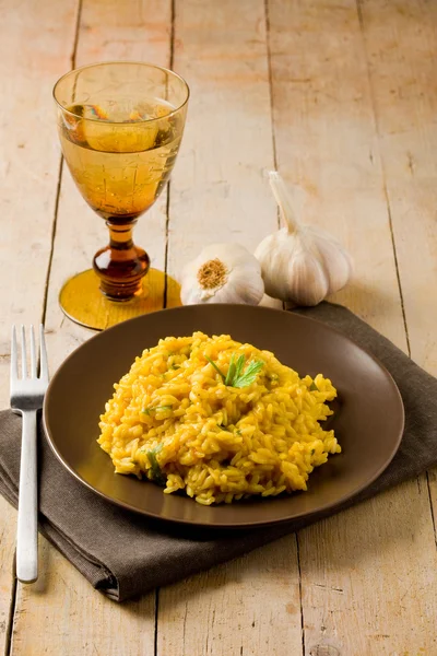 Risotto with Saffron on wooden table — Stock Photo, Image