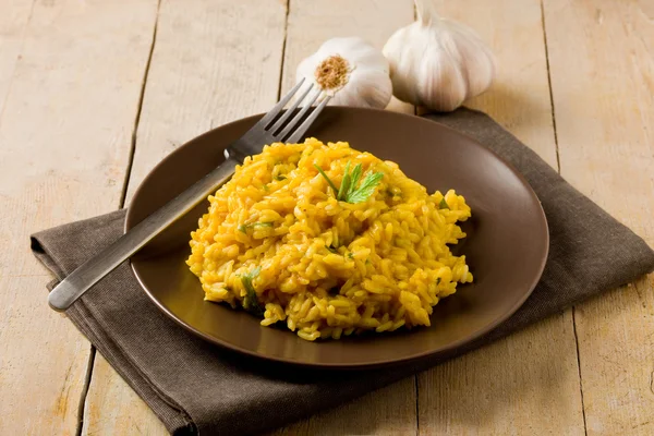 Risotto with Saffron on wooden table — Stock Photo, Image
