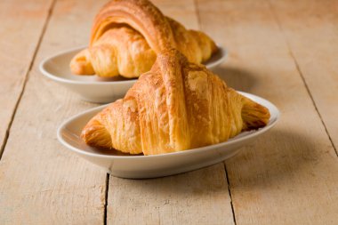 Croissants on wooden table clipart