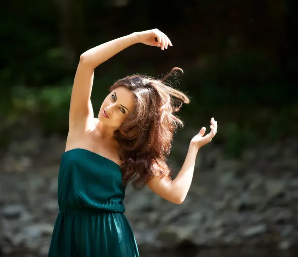 Portrait of a young woman with arms raised — Stock Photo, Image