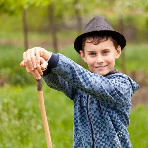 Chlapec s holí a klobouk venkovní — Stock fotografie