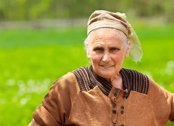 Old woman with kerchief outdoor — Stock Photo, Image