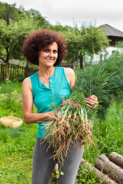 Young woman with a sheaf of dill — Stock Photo, Image