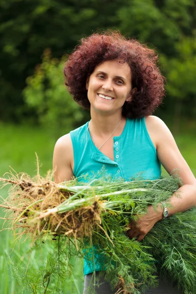 Young woman with a sheaf of dill — Stock Photo, Image