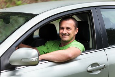 Happy young man with new car clipart