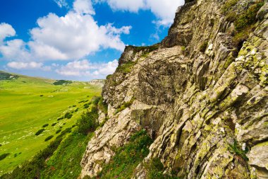 Huge cliff in Parang mountains in Romania clipart