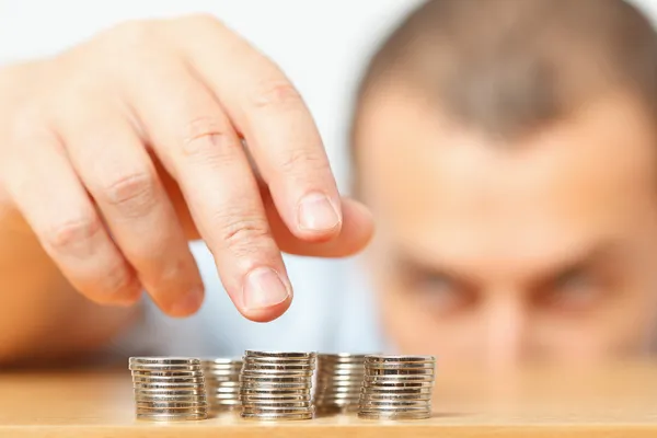 Businessman hand reaching for pennies — Stock Photo, Image