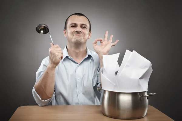 Businessman cooking a paperwork stew — Stock Photo, Image
