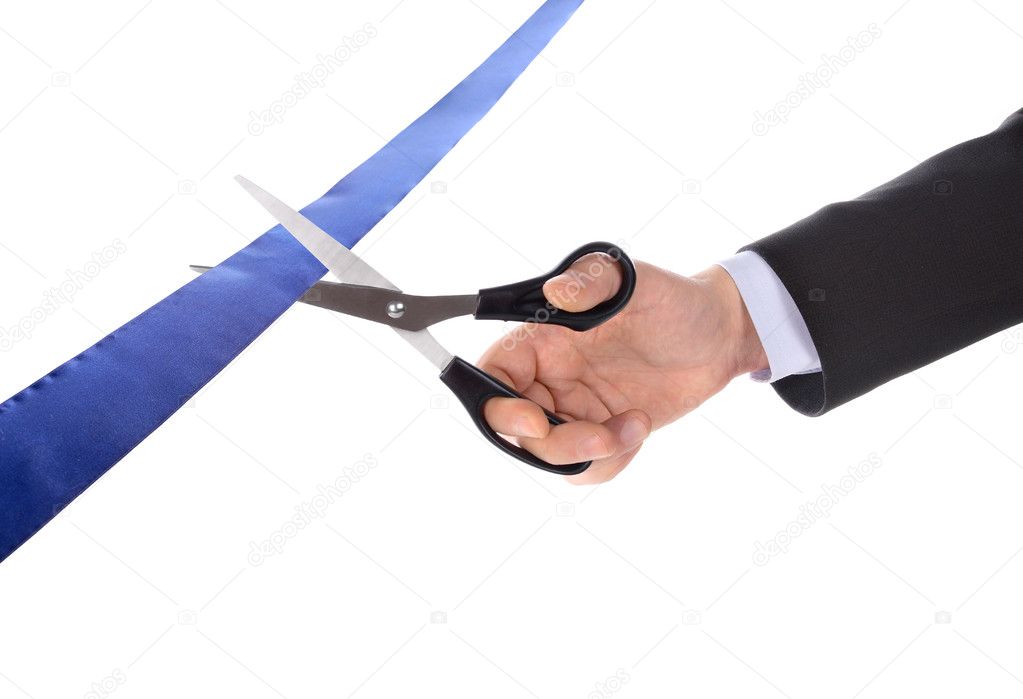 A man cutting a ribbon