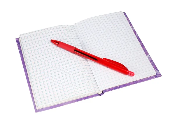 Ноутбук с красной ручкой — стоковое фото