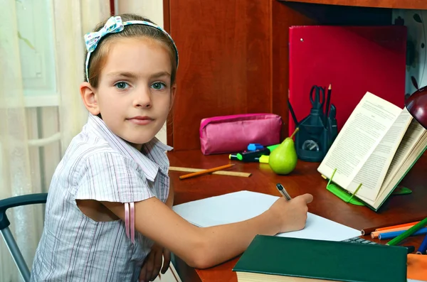 Girl at the educational table — Stock Photo, Image