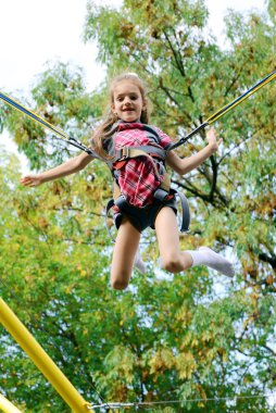 Girl jumping on elastic bands clipart