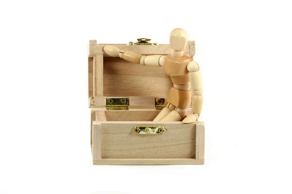 Wooden manikin in treasure chest — Stock Photo, Image