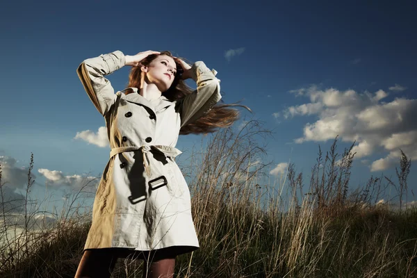 Fashion portrait of elegant woman in a raincoat — Stock Photo, Image