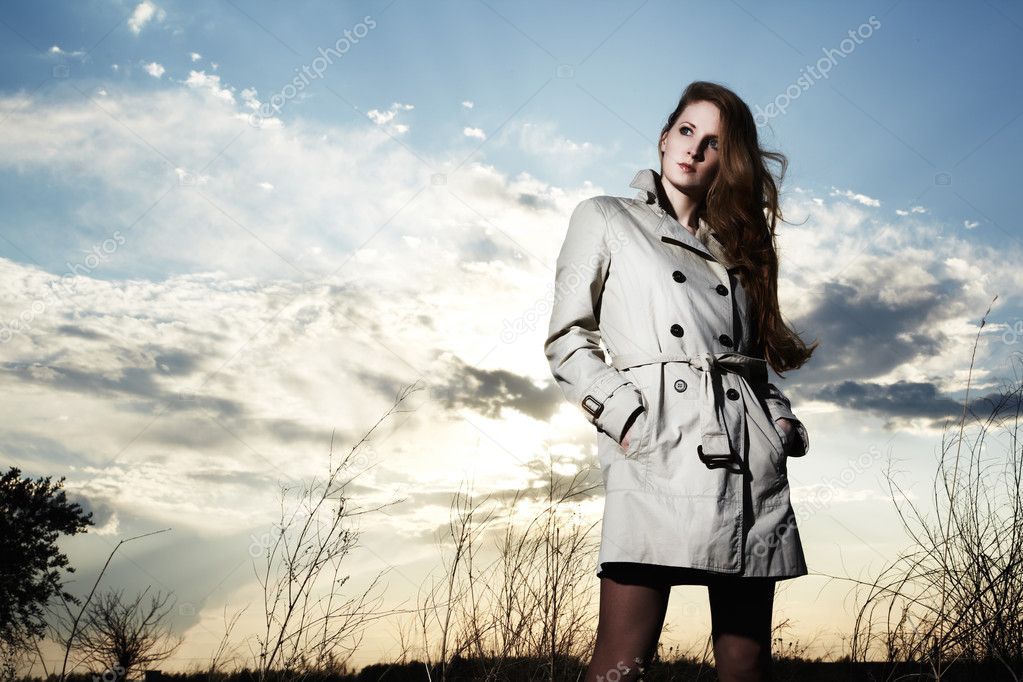 Fashion portrait of elegant woman in a raincoat