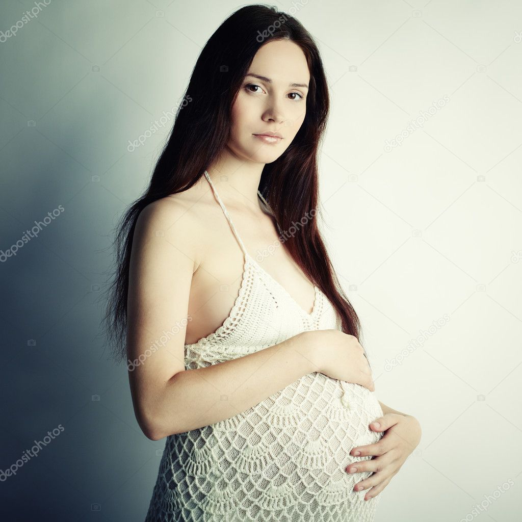 Fine art portrait of young pregnant woman