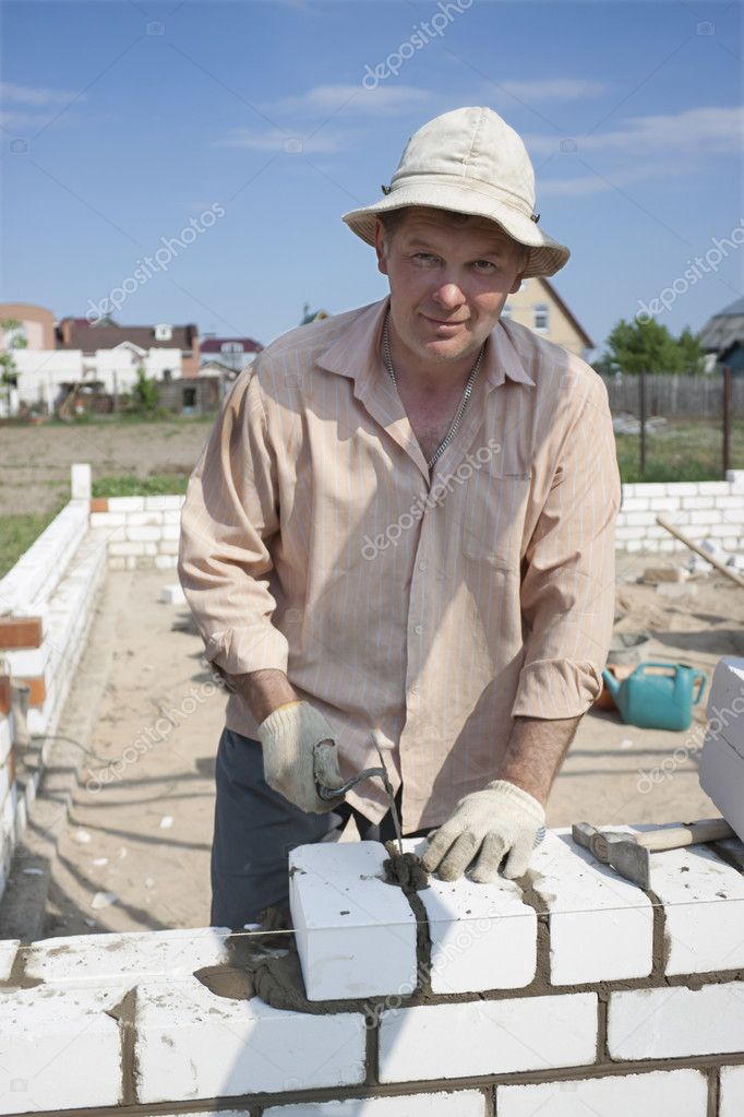 Bricklayer builds a wall