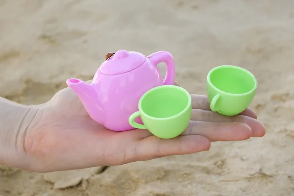 Toy cups on female hand — Stock Photo, Image