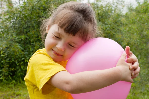 Baby girl and inflatable ball — Stock Photo, Image