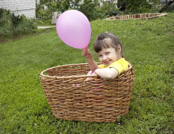 Baby girl in the basket with the ball — Stock Photo, Image