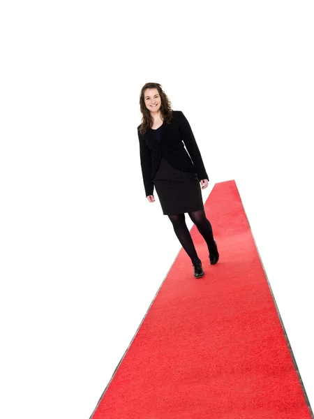 Ragazza sorridente che cammina sul tappeto rosso — Foto Stock