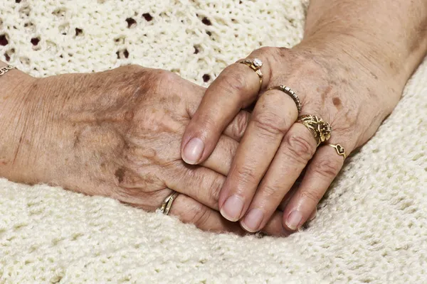Senior woman's crossed hands — Stock Photo, Image