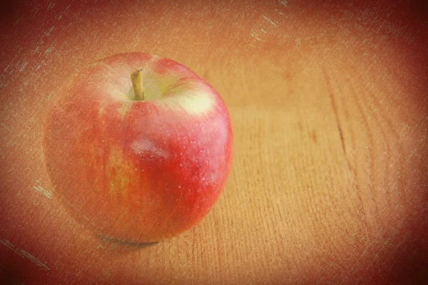 Vintage retro apple on wooden table — Stock Photo, Image