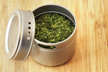 Parsley flakes in aluminum shaker clipart