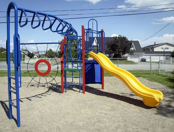 Yellow slide at the playground — Stock Photo, Image