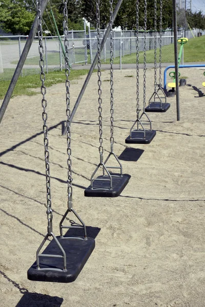 Empty black swings vertical — Stock Photo, Image