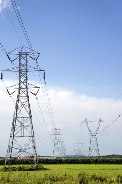 Two rows of electric pylons — Stock Photo, Image