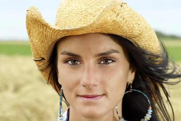 Portrait of cowgirl with hint of a smile — Stock Photo, Image