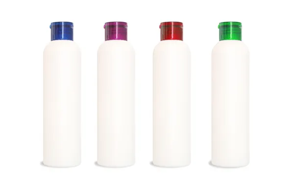 Quatro garrafas de cosméticos em branco — Fotografia de Stock